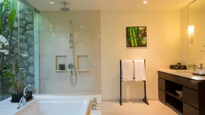 a bathroom with a bath tub and a shower at Jivana Beach Villas in Natai Beach