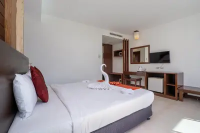 a hotel room with a bed and a television at Memory Karon Resort in Karon Beach