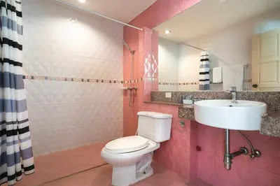 a bathroom with a white toilet and a sink at Memory Karon Resort in Karon Beach