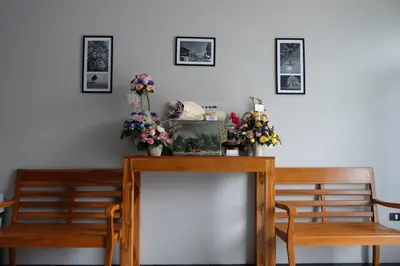 a dining room table with two chairs and flowers on it at The Besavana Phuket - SHA Extra Plus in Phuket Town