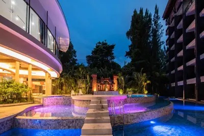 a night view of a building with a swimming pool at Areca Resort and Spa in Kathu