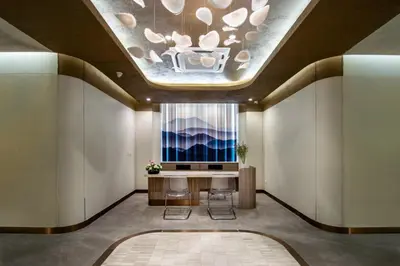 a lobby with a table and a large window at Areca Resort and Spa in Kathu