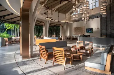 a lobby with chairs and a table and a bar at Areca Resort and Spa in Kathu