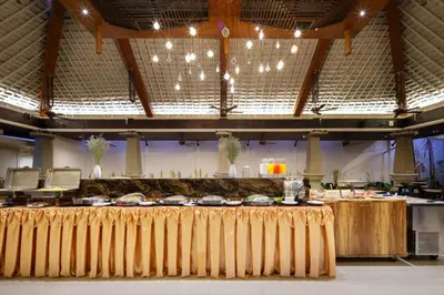 a buffet hall with a table with food on it at Areca Resort and Spa in Kathu