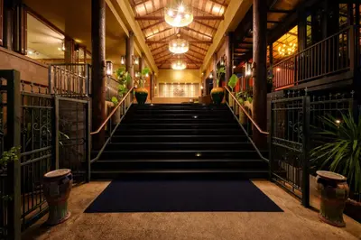 a set of stairs in a building with plants at Karon Phunaka Resort in Karon Beach