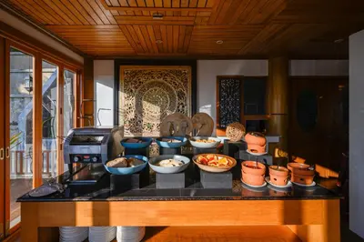 a counter with bowls of food on a table at Karon Phunaka Resort in Karon Beach