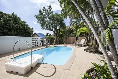 a swimming pool with a hot tub and palm trees at ViLLa JUNGLE 3 BEDROOMS in Kamala Beach