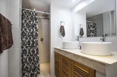 a bathroom with two sinks and a shower at ViLLa JUNGLE 3 BEDROOMS in Kamala Beach