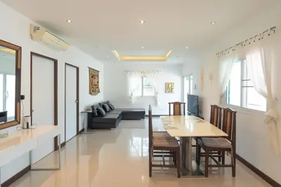 a dining room and living room with a table and chairs at JUNGLE APARTMENT2 BEDROOMS PRIVATE POOl in Kamala Beach