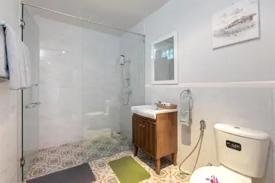 a bathroom with a shower and a toilet and a sink at Kamala Beach House - 1 min walk to beach in Kamala Beach