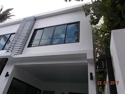 a white house with a lot of windows on it at Kamala Beach House - 1 min walk to beach in Kamala Beach