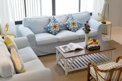 a living room with a white couch and a table at Kamala Beach House - 1 min walk to beach in Kamala Beach