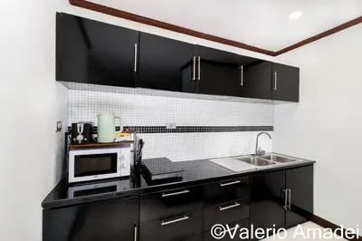 a kitchen with a microwave and a sink at Patong Tower Amazing Sea View 12 by PHR in Patong Beach