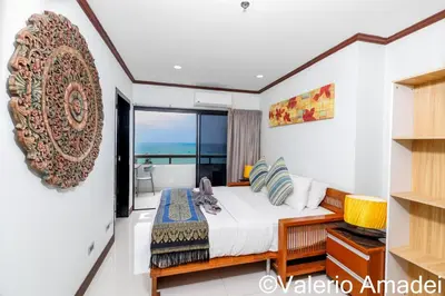 a bedroom with a bed and a view of the ocean at Patong Tower Amazing Sea View 12 by PHR in Patong Beach
