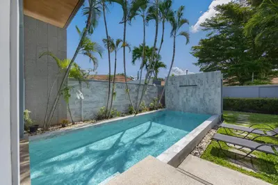 a swimming pool in the backyard of a house with palm trees at VILLA Galam 2BR Private Pool Naiharn beach in Nai Harn Beach
