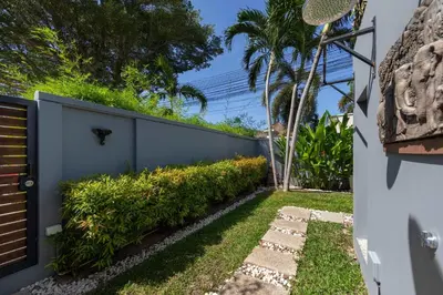 a backyard with a fence and a garden at VILLA Galam 2BR Private Pool Naiharn beach in Nai Harn Beach