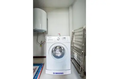 a washing machine sitting in a room next to at VILLA ATA Private Pool Nai harn beach in Nai Harn Beach