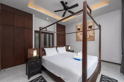 a bedroom with a bed and a ceiling fan at VILLA ATA Private Pool Nai harn beach in Nai Harn Beach