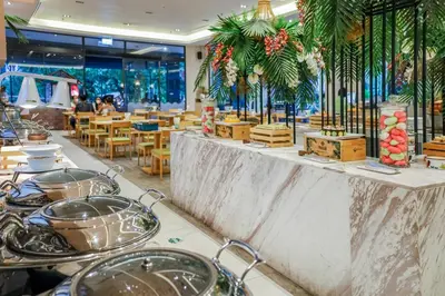 a restaurant with a counter with pots and pans at Panan Krabi Resort in Ao Nang Beach