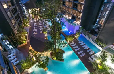 an overhead view of a swimming pool with chairs and trees at Panan Krabi Resort in Ao Nang Beach