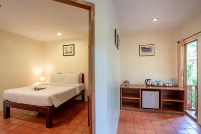 a bedroom with a bed and a television in a room at Bangtao Village Resort - SHA in Bang Tao Beach