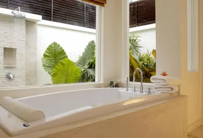 a bath tub in a bathroom with a window at The Racha in Ko Racha Yai