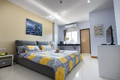 a bedroom with a bed and a television in it at YaYa B By Briza Group in Chalong