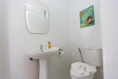 a white bathroom with a sink and a toilet at YaYa B By Briza Group in Chalong
