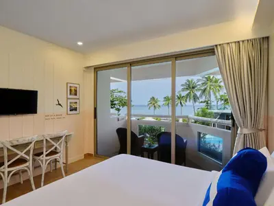a hotel room with a bed and a view of the ocean at Homm Bliss Southbeach Patong in Patong Beach