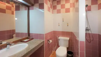 a bathroom with a toilet and a sink at Tony Resort in Patong Beach