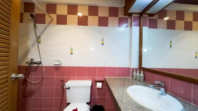 a bathroom with a toilet and a sink at Tony Resort in Patong Beach