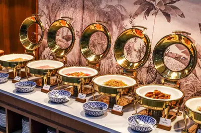 a display of plates and bowls of food on a table at Tony Resort in Patong Beach