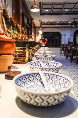 a row of blue and white bowls on a table at Tony Resort in Patong Beach