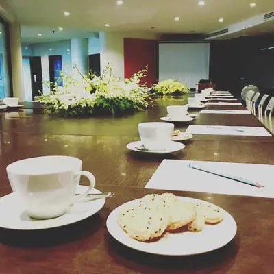 a long wooden table with cups and plates of food at I Pavilion Hotel Phuket in Phuket Town