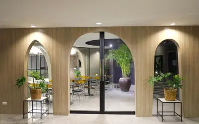 a lobby with arches and a table with potted plants at I Pavilion Hotel Phuket in Phuket Town