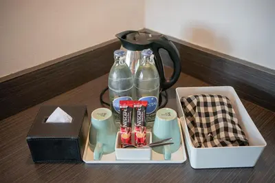 a tray with two bottles of water and a black blender at I Pavilion Hotel Phuket in Phuket Town