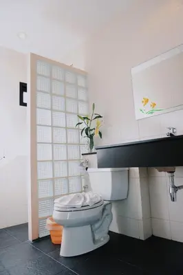 a bathroom with a white toilet and a sink at Ice Kamala Beach Hotel in Kamala Beach