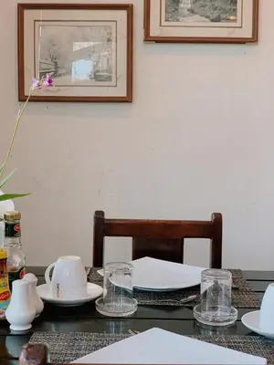 a table with plates and glasses on top of it at Ice Kamala Beach Hotel in Kamala Beach