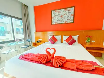 a bedroom with a bed with a heart decoration on it at PJ Patong Resortel in Patong Beach