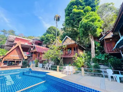 a resort with a swimming pool and some buildings at Golden Hill Guesthouse in Phi Phi Don
