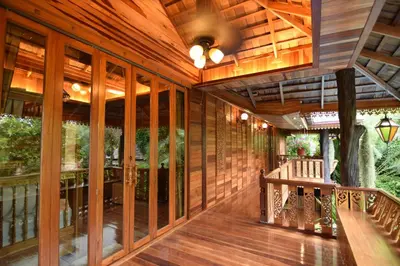 an open porch with wooden walls and wood flooring at Baan Habeebee Resort in Ao Nang Beach