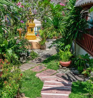 a garden with plants and a stone path at Kata Leaf Resort Phuket - in Kata Beach