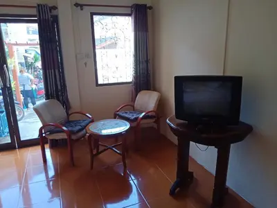 a living room with three chairs and a television at Kata Leaf Resort Phuket - in Kata Beach