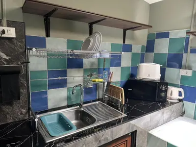 a kitchen with a sink and a counter top at Kata Leaf Resort Phuket - in Kata Beach
