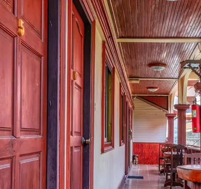 a hallway with a red door and a table and chairs at Kata Leaf Resort Phuket - in Kata Beach