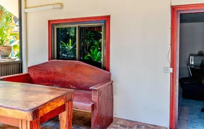 a red chair and a table in a room at Kata Leaf Resort Phuket - in Kata Beach
