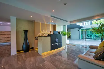 a lobby with a reception desk in a building at Oceanstone by RESAVA in Bang Tao Beach