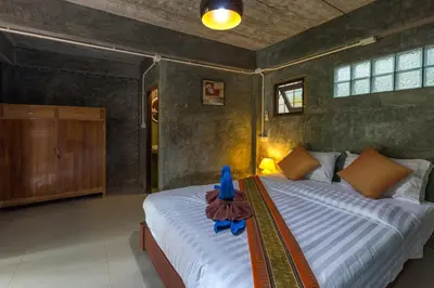 a bedroom with two beds in a room at Kanya Cozy Bungalows Kata in Kata Beach