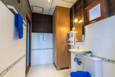 a bathroom with a sink and a toilet at Kanya Cozy Bungalows Kata in Kata Beach