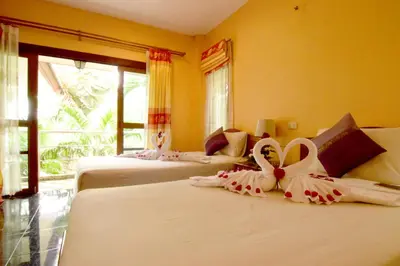 a room with three beds with bows on them at Aonang Lake Side in Ao Nang Beach